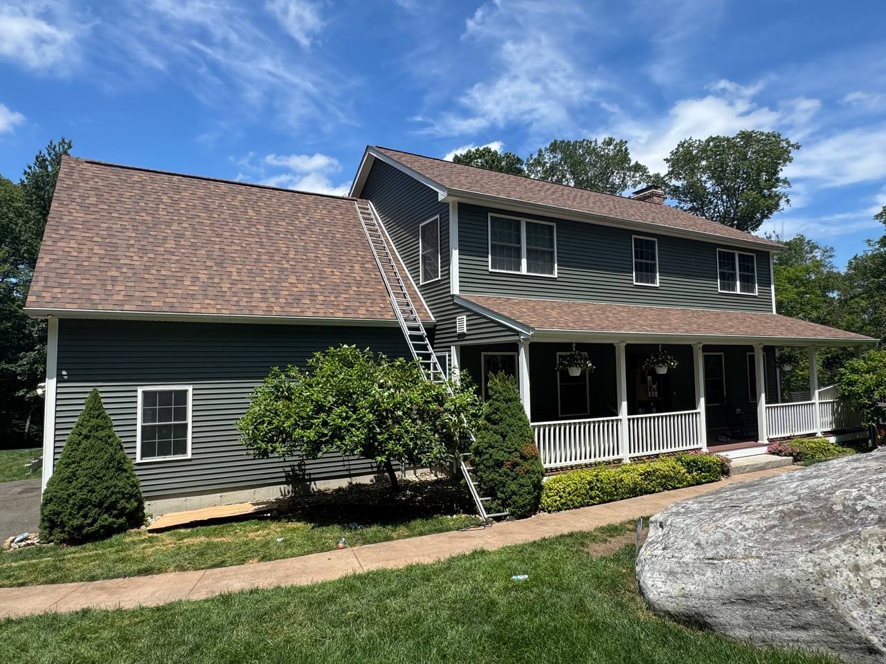 Colonial style house with brand new green siding