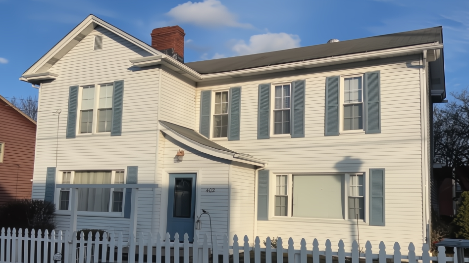 before house with dated siding and old roof